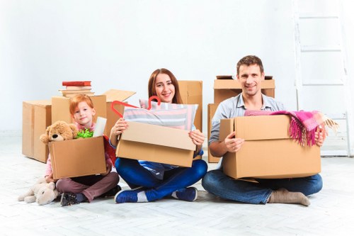 House removal team carrying furniture through a South London residential property