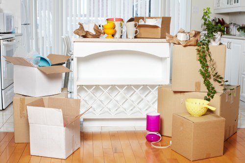 Professional movers loading household items into a van