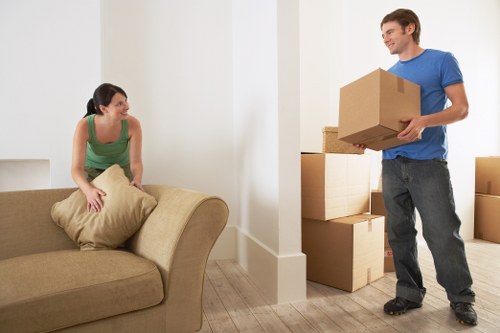 Packed moving boxes and furniture ready for transport in South London